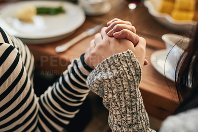 Buy stock photo Hands, pray and family at a table for food, blessing and gratitude before sharing a meal in their home together. Hand holding, worship and people praying before eating, prayer and religious respect