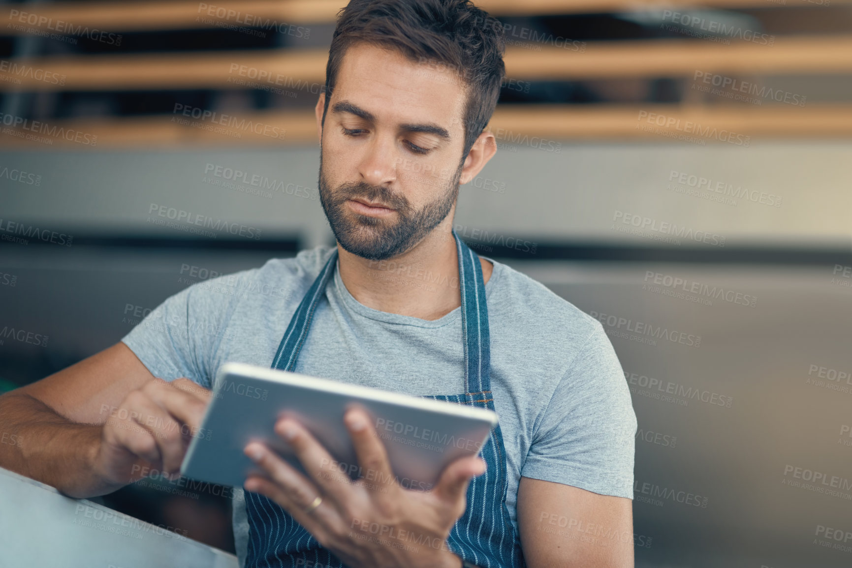 Buy stock photo Cafe, waiter and man with internet on tablet for online order, communication or restaurant app. Small business, worker and reading with tech at coffee shop for web sale, processing or digital service