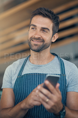 Buy stock photo Happy, man and thinking with phone at cafe for restaurant app, communication and digital service. Small business, waiter and smile with tech at coffee shop for online order, processing or menu update