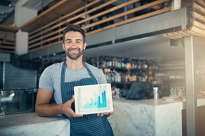 Buy stock photo Portrait of a young man holding a digital tablet with a graph on the screen at a coffee shop