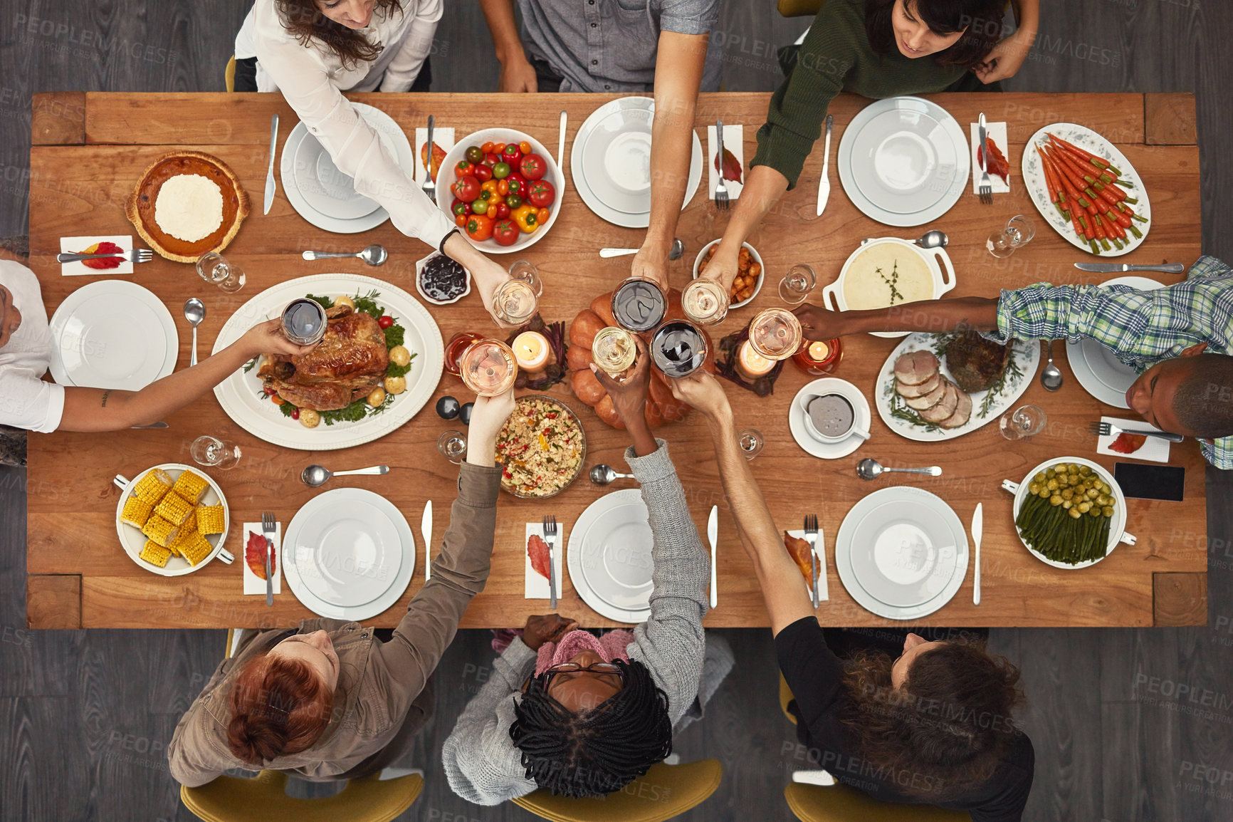 Buy stock photo Food, top view and friends toast at a table in celebration of thanksgiving at a party or social event together. Cheers, support and happy people with diversity, support and trust enjoy a dinner meal