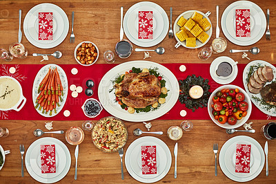 Buy stock photo Christmas, party and food with a festive feast on a dinner table in a home from above for celebration. Chicken, event and nutrition with a meal setting on a wooden surface in the holiday season