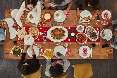 Buy stock photo Shot of a group of people sitting together at a dining table ready to eat
