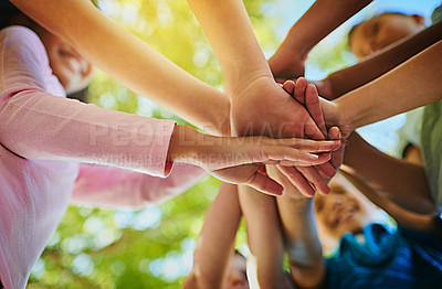 Buy stock photo Shot of an unrecognizable group of young friends hands huddled together outside