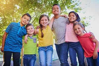 Buy stock photo Shot of a diverse group of children holding each other outside
