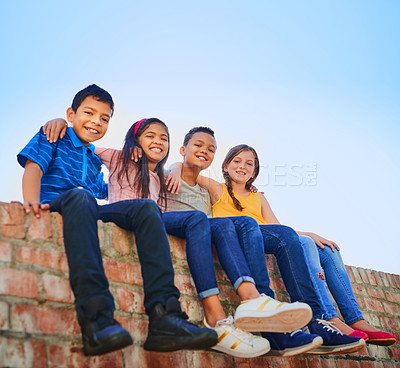 Buy stock photo Shot of a diverse group of young friends holding each other outside