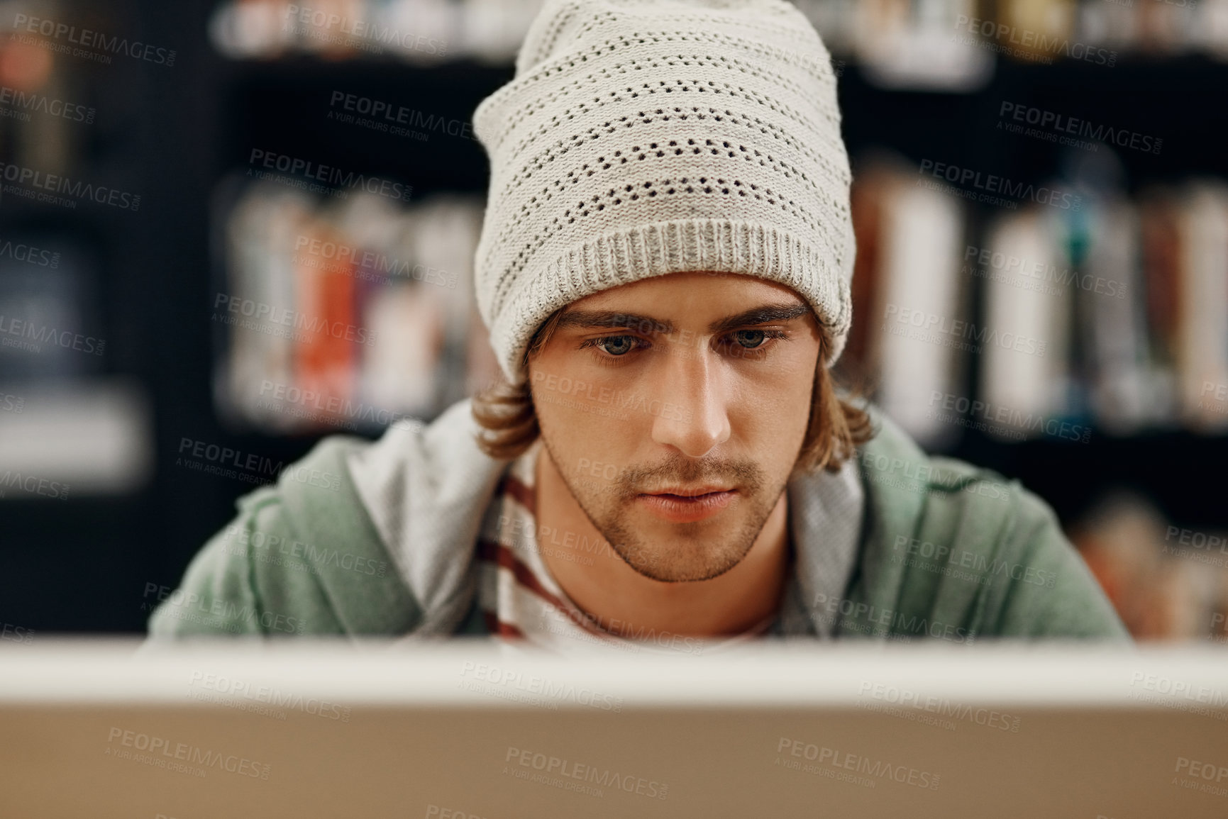 Buy stock photo High angle shot of a young male university student studying in the library