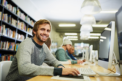 Buy stock photo Cropped portrait of a young male university student studying in the library