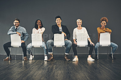 Buy stock photo Studio shot of a diverse group of creative employees sitting on chairs inside
