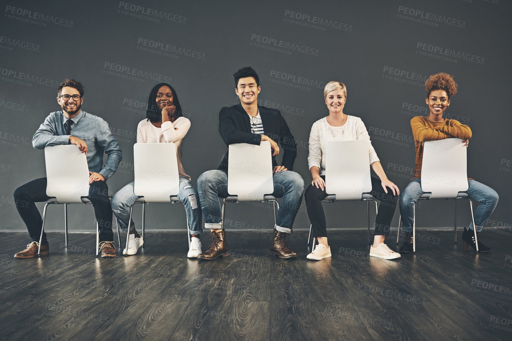 Buy stock photo Studio shot of a diverse group of creative employees sitting on chairs inside