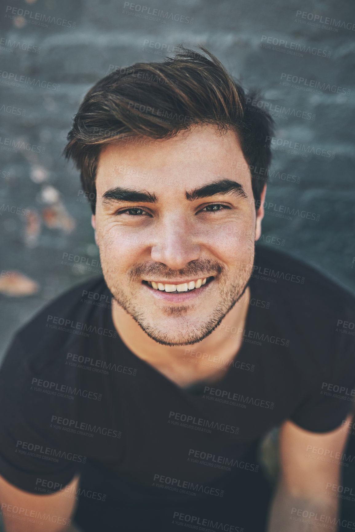 Buy stock photo Laughing, happy and smiling face of a student isolated against a grey city wall outside. Portrait and headshot of a stylish, cool and funky young man enjoying a weekend break alone in town