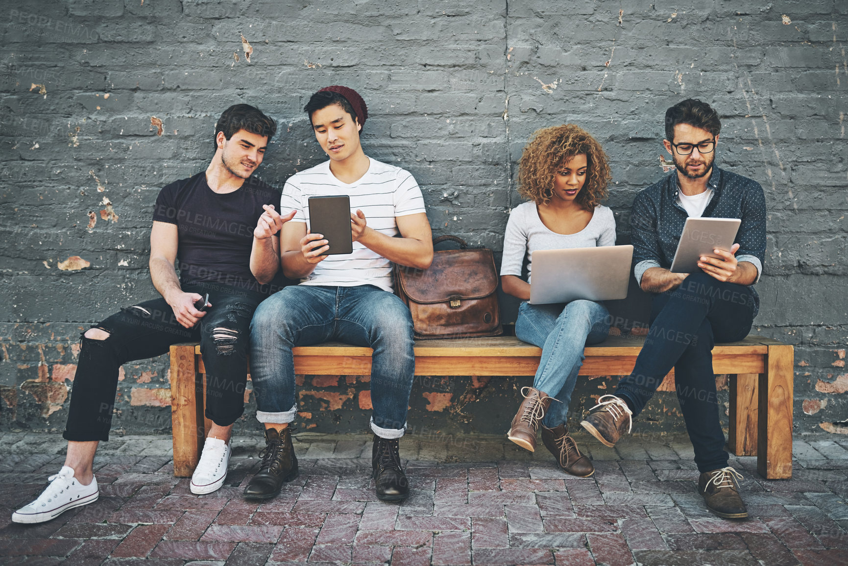 Buy stock photo Shot of a diverse group of people social networking outside