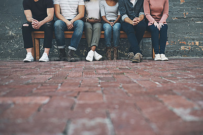 Buy stock photo Shot of a group of unrecognizable people sitting outside