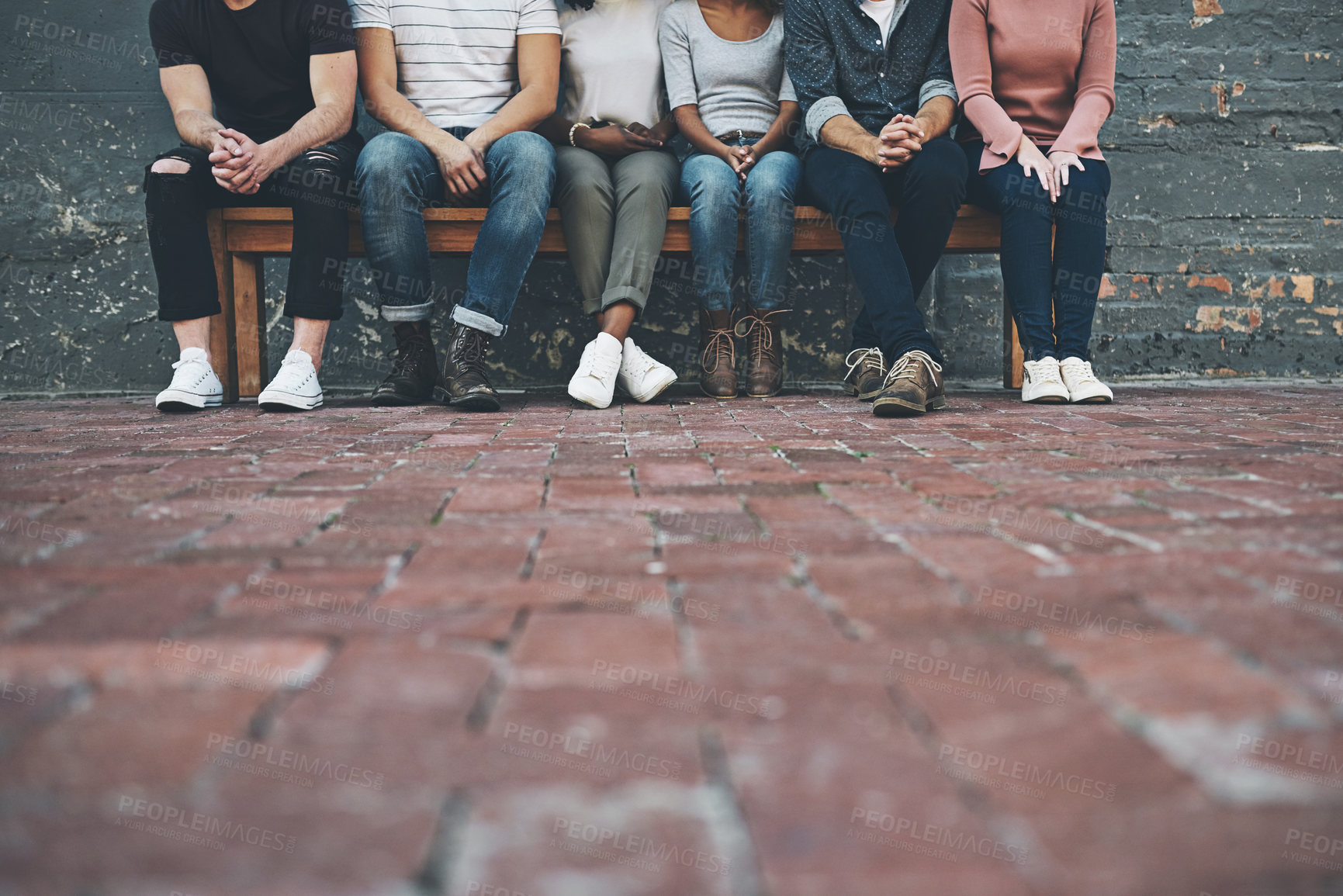 Buy stock photo Shot of a group of unrecognizable people sitting outside