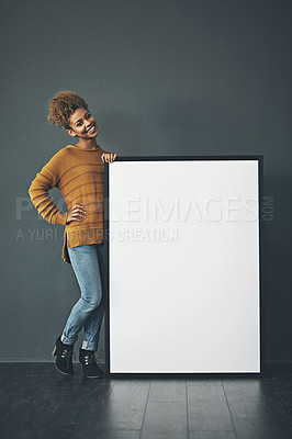 Buy stock photo Young woman holding and showing an empty or blank sign for voicing an idea or advertisement announcement. Happy, excited and cheerful designer standing with mockup whiteboard or copyspace banner.