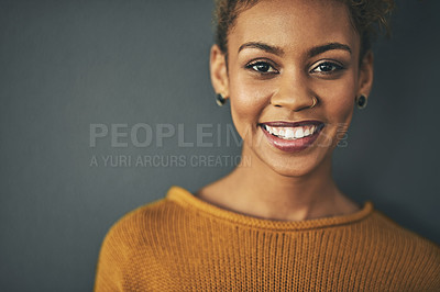 Buy stock photo Studio portrait of an attractive young woman standing against a grey background