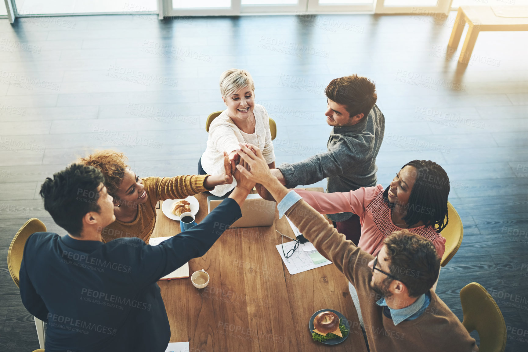 Buy stock photo Shot of a group of businesspeople joining their hands together in unity in an office