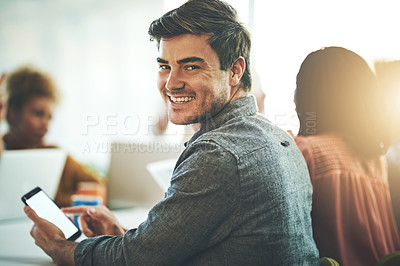Buy stock photo Portrait of a businessman using a cellphone with his colleagues in the background