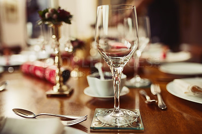 Buy stock photo Closeup shot of a wineglass on a table during Christmas