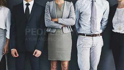 Buy stock photo Cropped studio shot of a group of businesspeople standing in line against a gray background