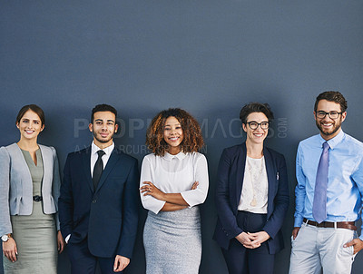 Buy stock photo Studio shot of a group of businesspeople standing in line against a gray background