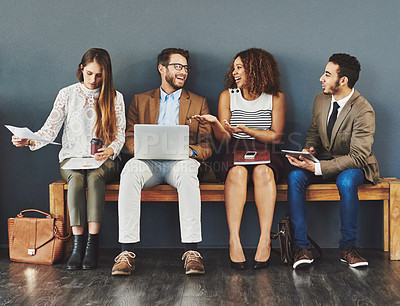 Buy stock photo Technology, interview and skills of diverse people waiting in line and sitting in a row while talking and sharing tips for success. Multiracial men and women as candidates for digital marketing job