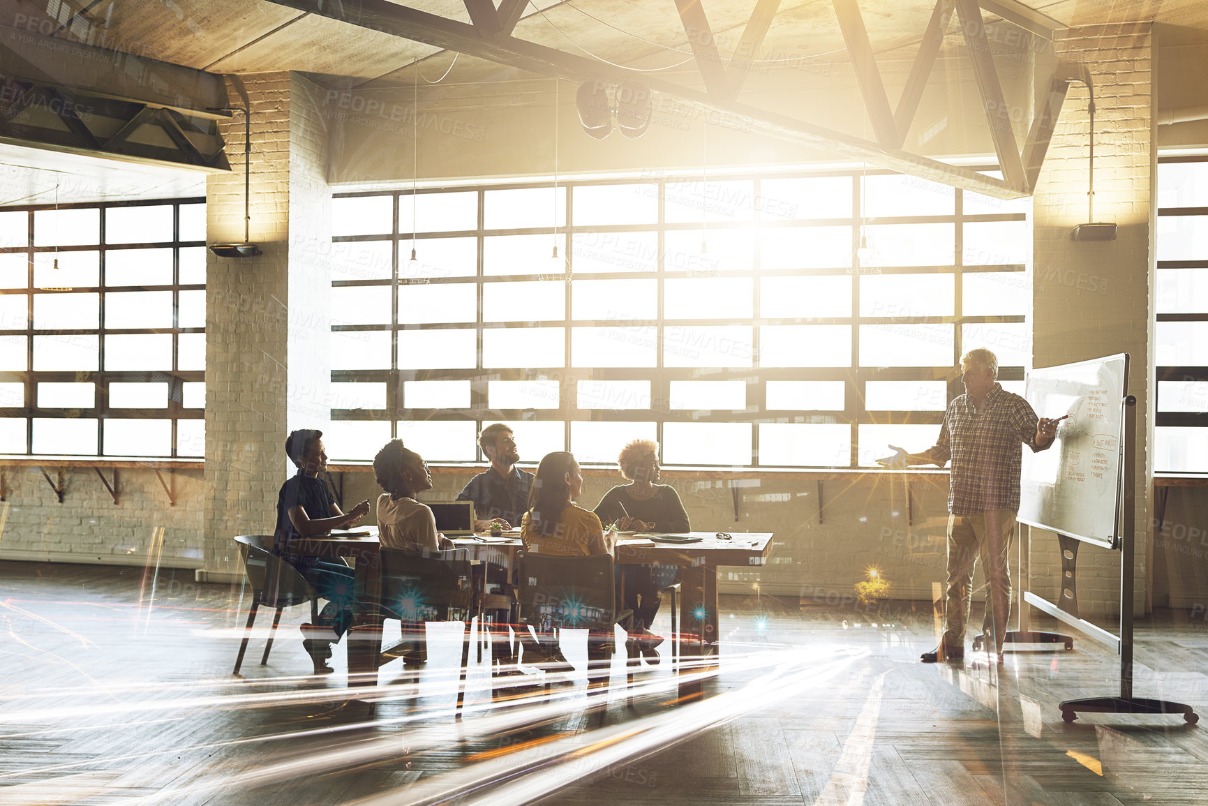 Buy stock photo Multiple exposure shot of businesspeople having a meeting superimposed over a cityscape