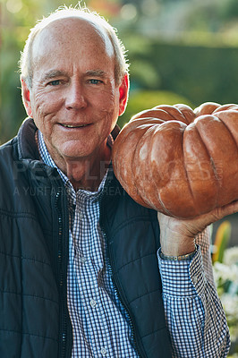 Buy stock photo Portrait of a senior man holding a pumpkin outside