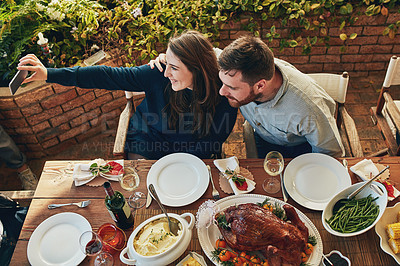 Buy stock photo Cropped shot of a couple taking a selfie while eating outside