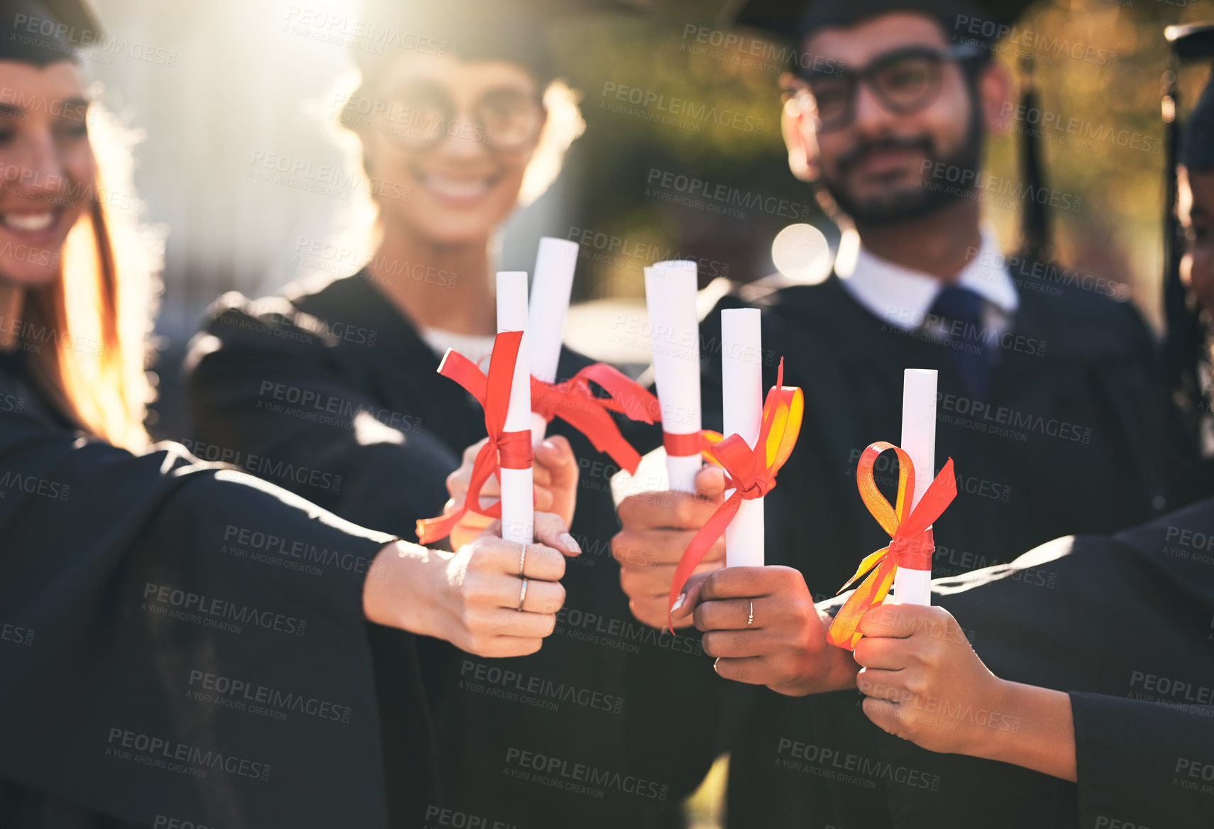 Buy stock photo Degree, students and graduation huddle in outdoor, diploma celebration and solidarity for support. People, friends and certified together for university success, diversity and study achievement goal