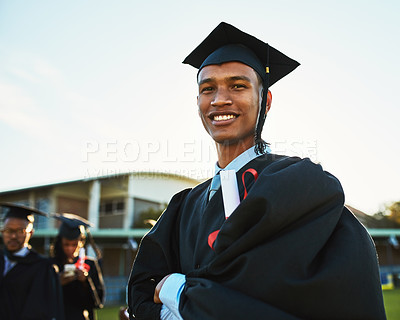 Buy stock photo Portrait of a confident young man holding a diploma on graduation day