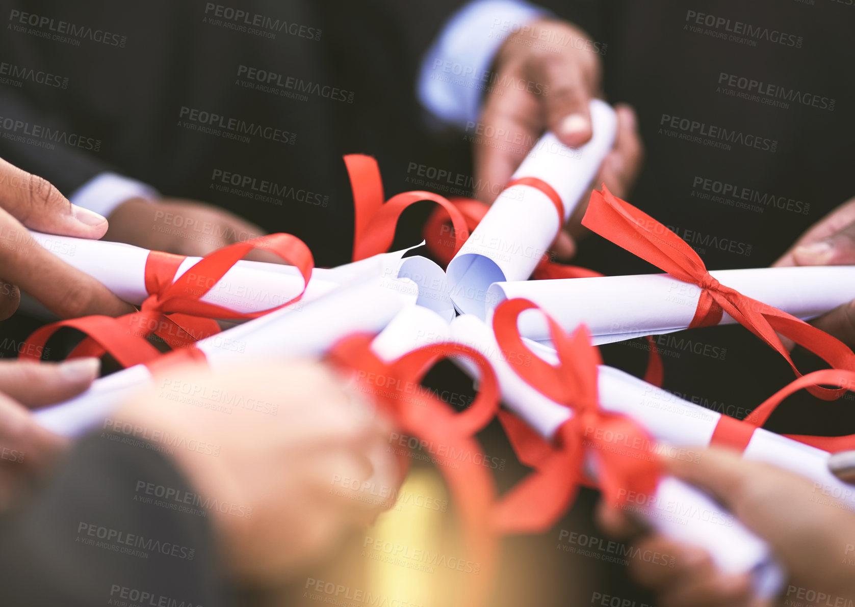 Buy stock photo Shot of a group of students holding their diplomas together on graduation day