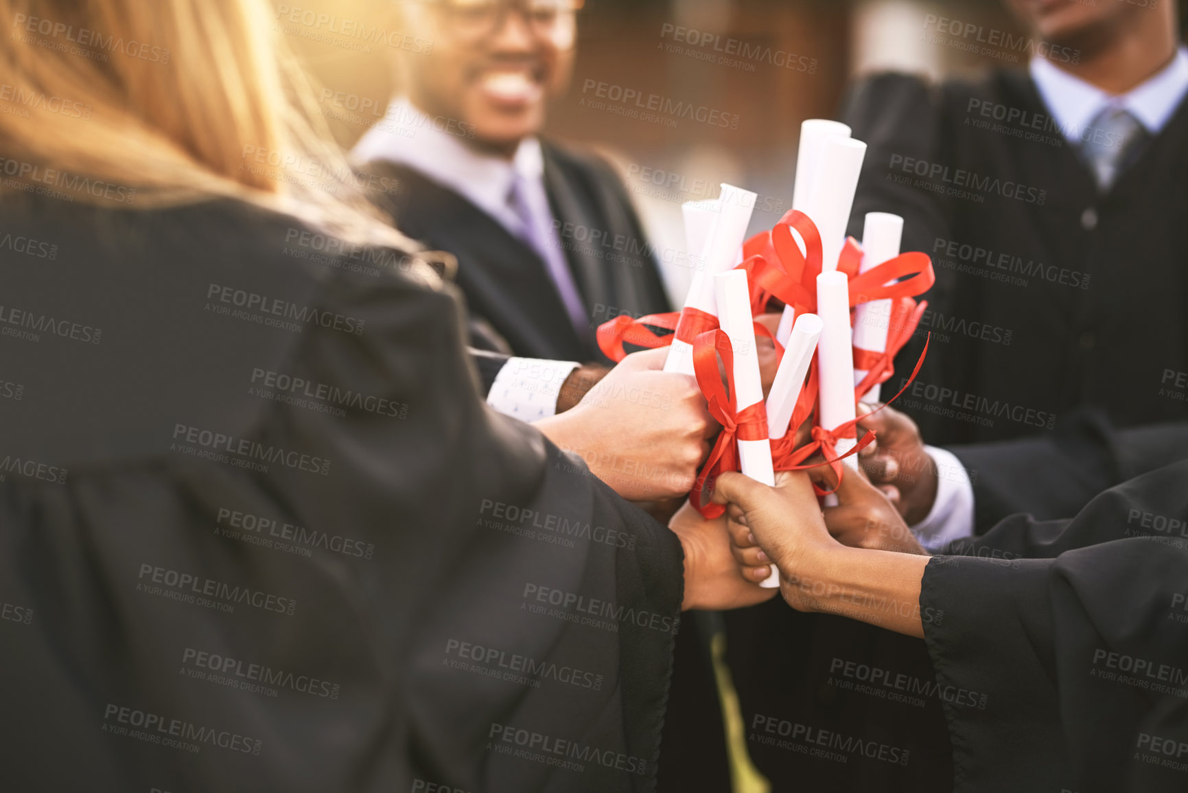 Buy stock photo Graduation, certificate and hands of team for celebration, award or learning milestone. People, group and graduate students with diploma scroll closeup for education achievement or success at college