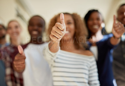 Buy stock photo Shot of a diverse group of students showing thumbs up at campus