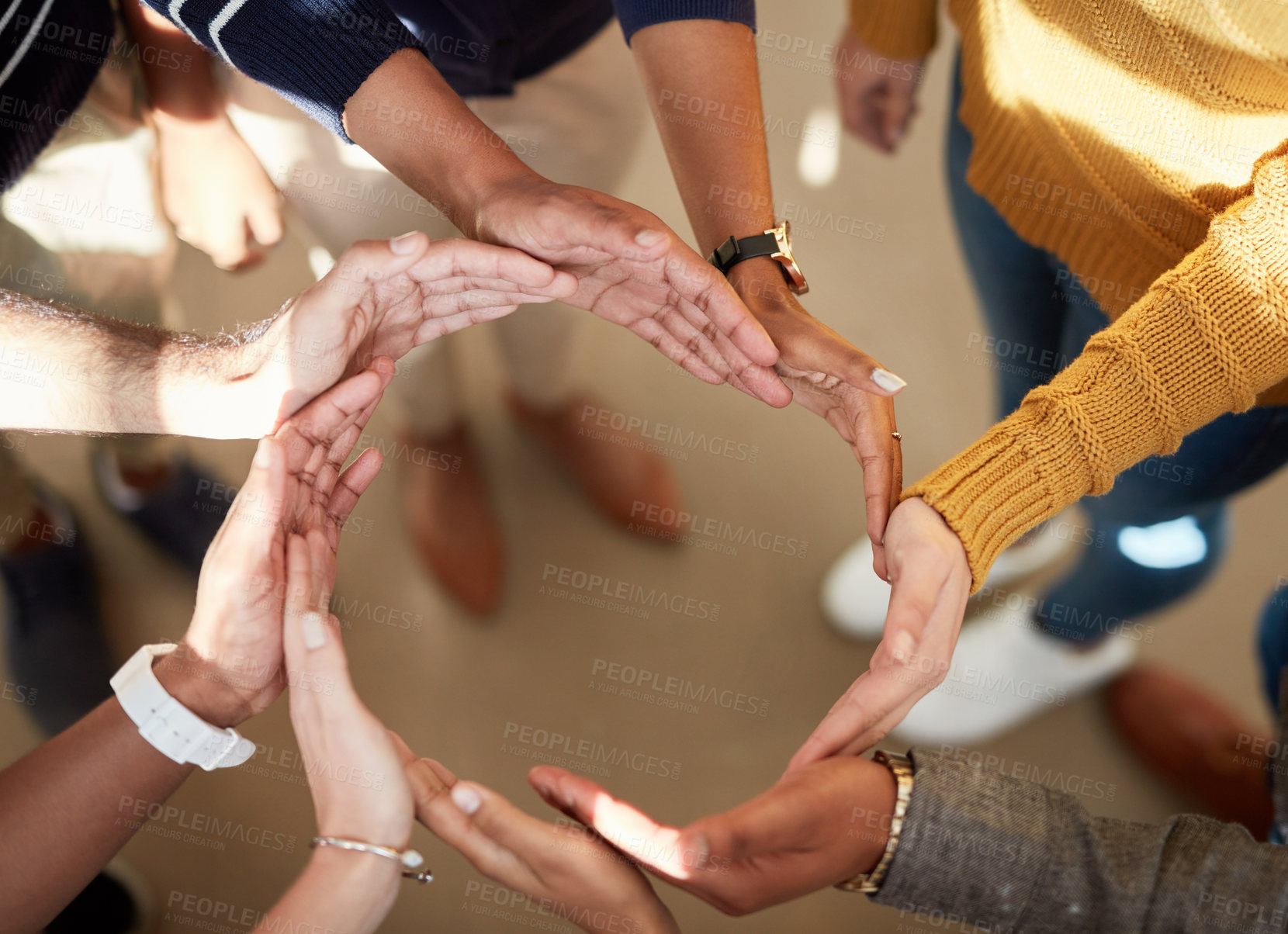 Buy stock photo High angle shot of a group of people joining their hands together