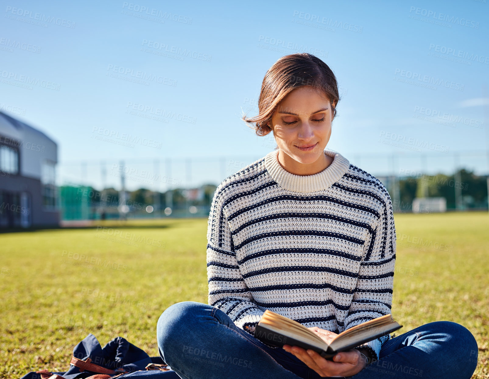 Buy stock photo Reading, smile and woman in nature, studying and book of literature, outdoor and education for student. Knowledge, campus and learning in college, person and girl in school, scholarship and grass