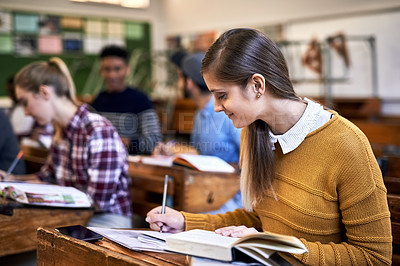 Buy stock photo Cropped shot of university students sitting in class