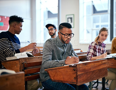 Buy stock photo Cropped shot of university students sitting in class