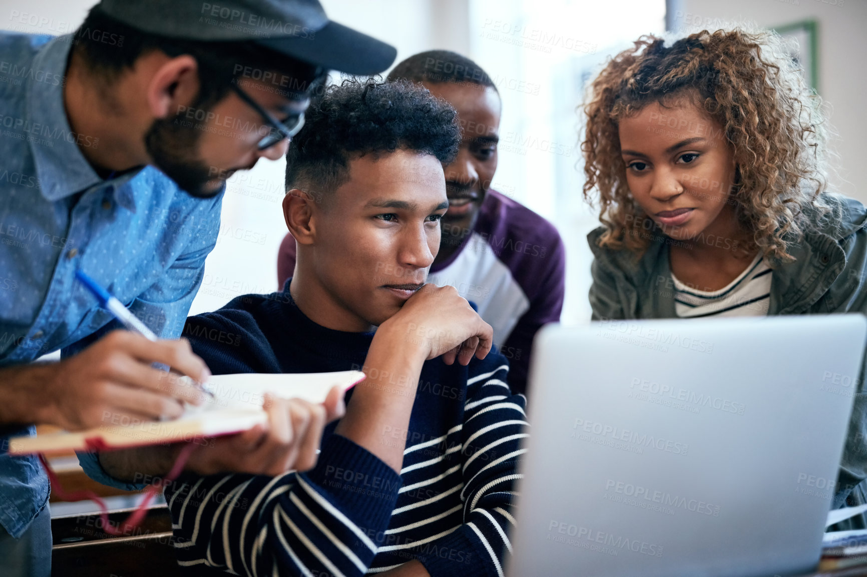 Buy stock photo Cropped shot of university students using a laptop together in class