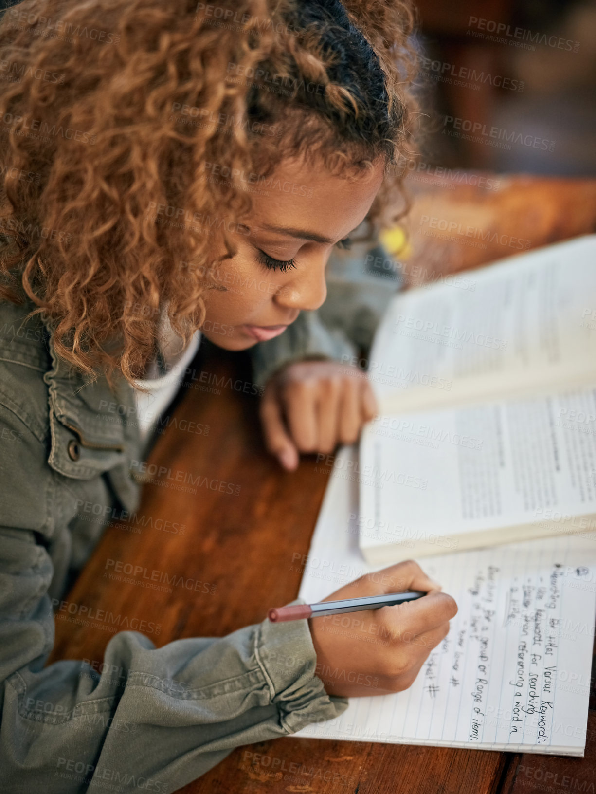 Buy stock photo Cropped shot of an university student writing notes in class