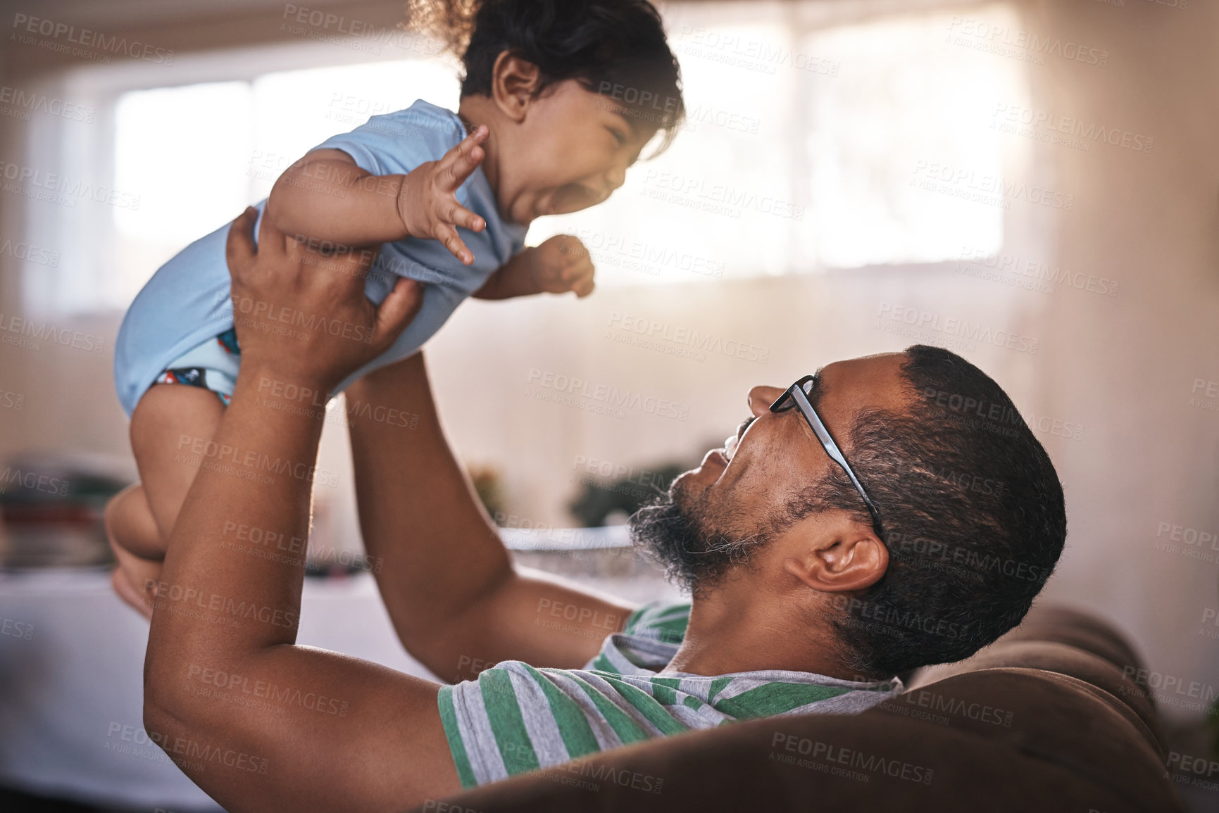 Buy stock photo Smile, father and lifting baby at house with airplane game, bonding and support for fantasy play on weekend. Excited, man and boy for love, trust and child motor or sensory development at home
