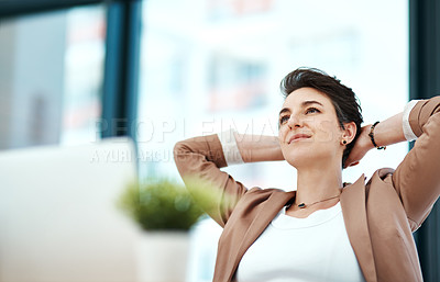 Buy stock photo Shot of a young designer looking relaxed at her desk