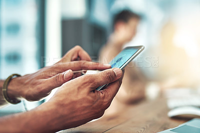 Buy stock photo Cropped shot of a designer using his cellphone at his desk