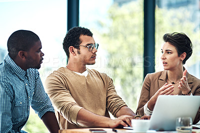 Buy stock photo Cropped shot of three designers having a brainstorming session at the office