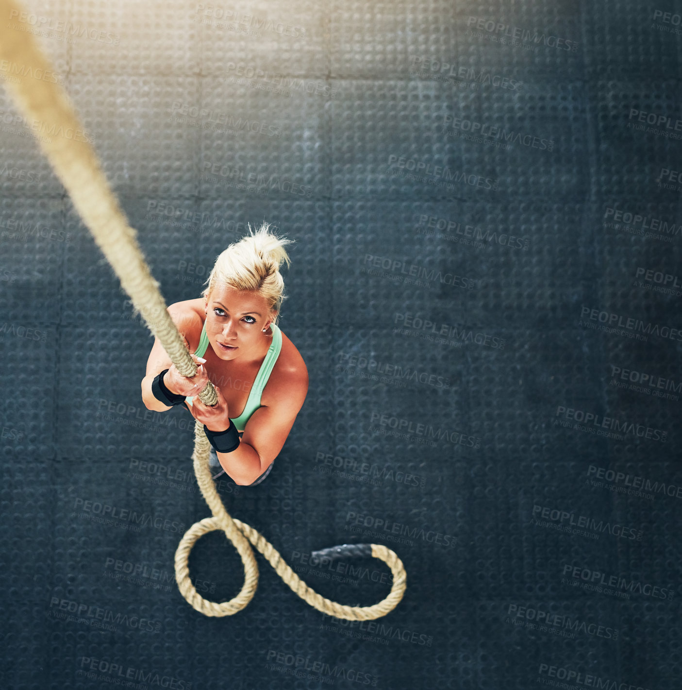 Buy stock photo Above, rope climbing and woman in gym, fitness and energy with wellness, endurance and challenge. Person, bodybuilder or girl with exercise, top view and training with full body workout or motivation