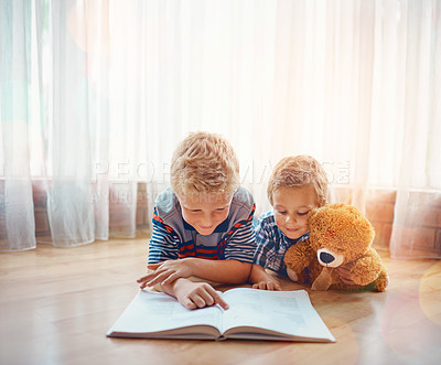 Buy stock photo Reading, teddy bear and children with book on floor in home for bonding, learning or knowledge. Happy, relax and boy kids or siblings with fantasy novel, story or literature together with plush toy.