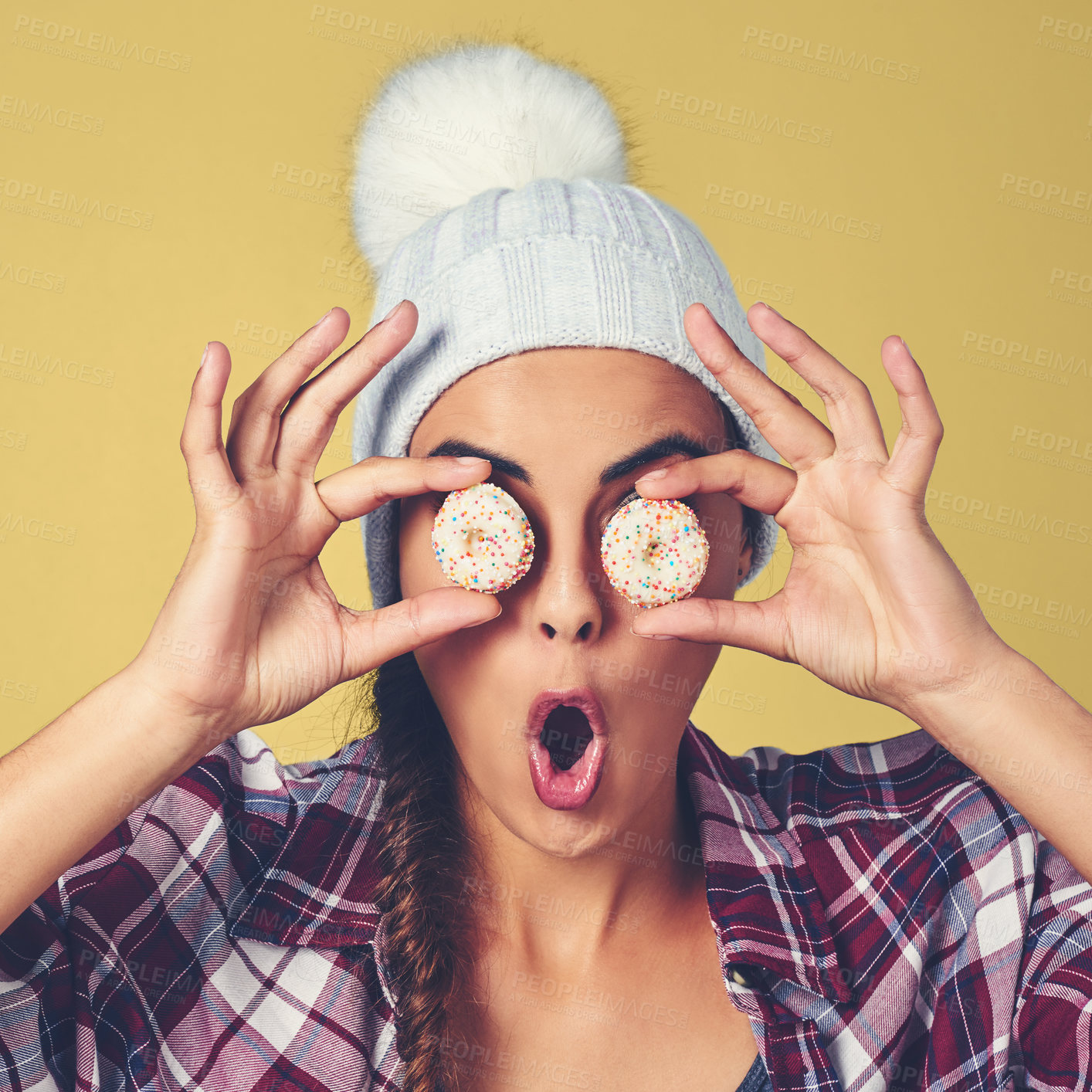 Buy stock photo Cookies, shock and face of woman in studio for pastry chef, sweet and confectionery bakery. Wow, sugar and news with person and biscuit on eyes on yellow background for dessert, food and candy