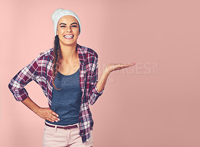 Buy stock photo Shot of an attractive young woman showing you copyspace against a pink background