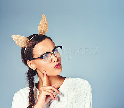 Buy stock photo Studio shot of a young woman wearing costume rabbit ears against a plain background