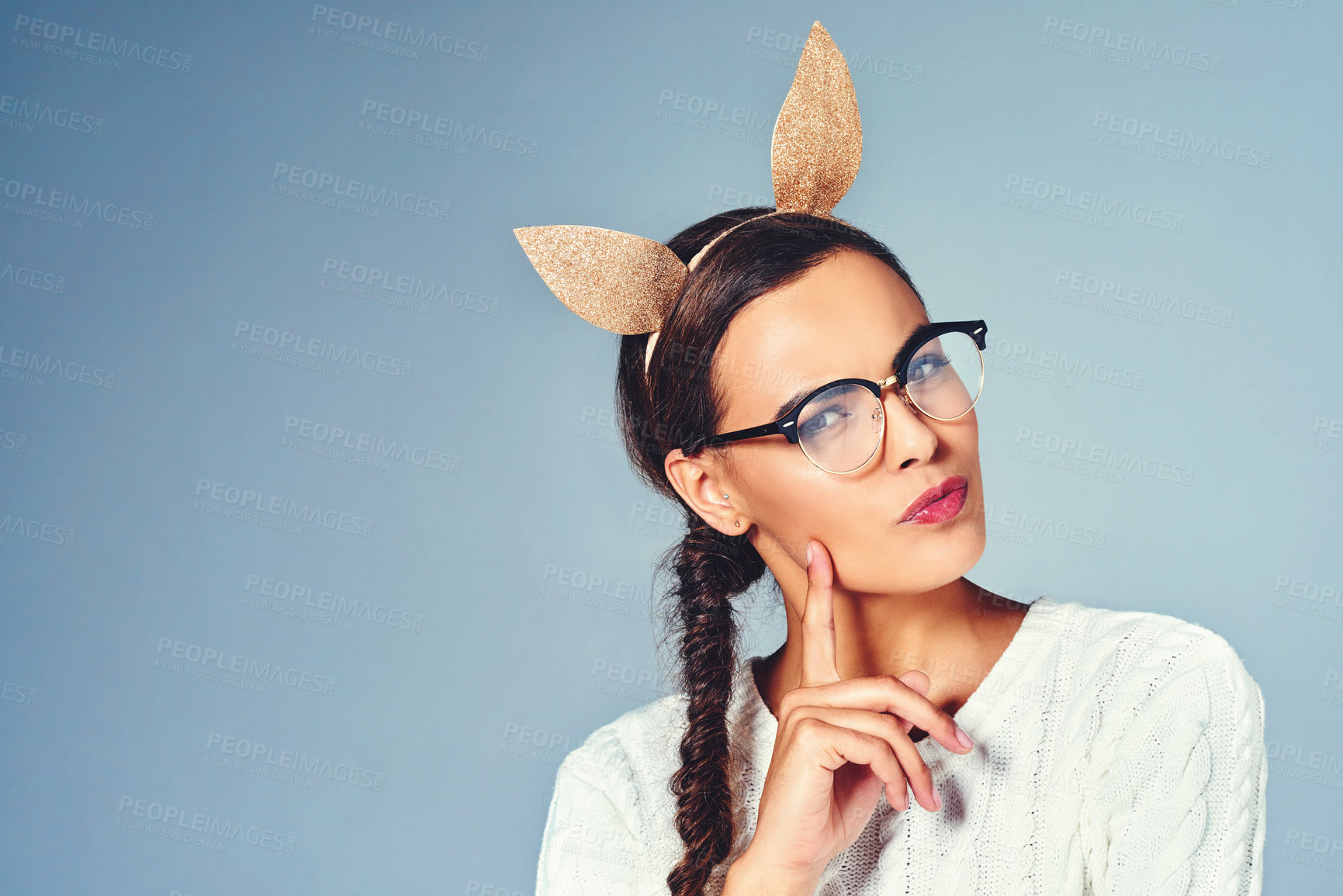 Buy stock photo Ideas, animal ears and portrait of woman in studio for halloween costume with mockup space. Thinking, glasses and female person from Brazil with novelty headband for dress up by blue background.